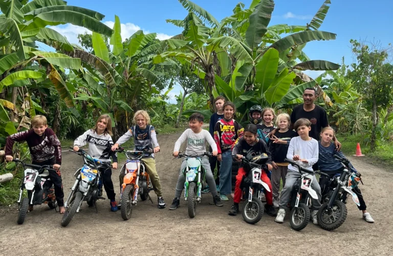 A group of young boys on dirt bikes in the jungle