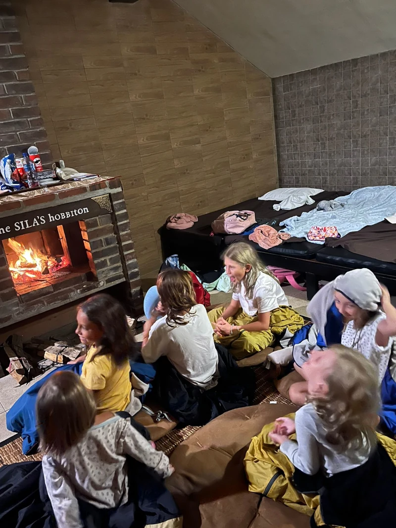 A group of girls on a sleepover at a hobbit house.