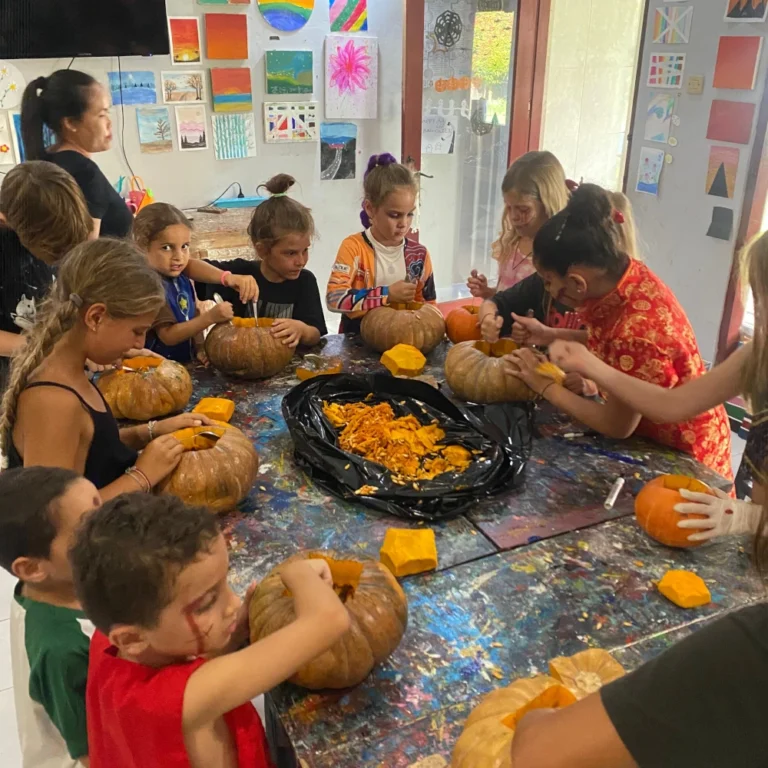 A group of children around a table making halloween pumpkins