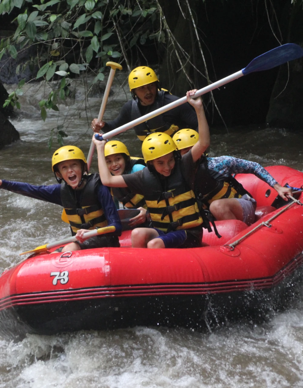 A group of children rafting on a river in Bali