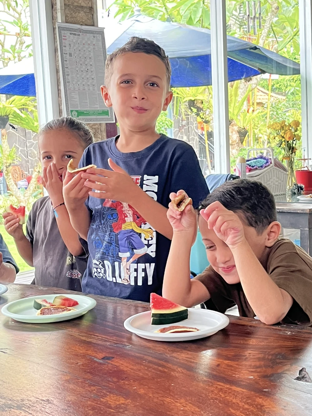 Some children eating fruit at the table
