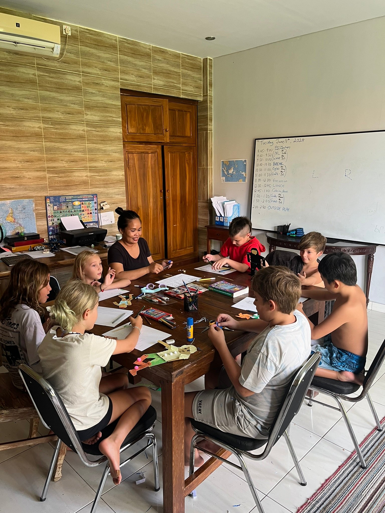 A group of children around a table making halloween pumpkins